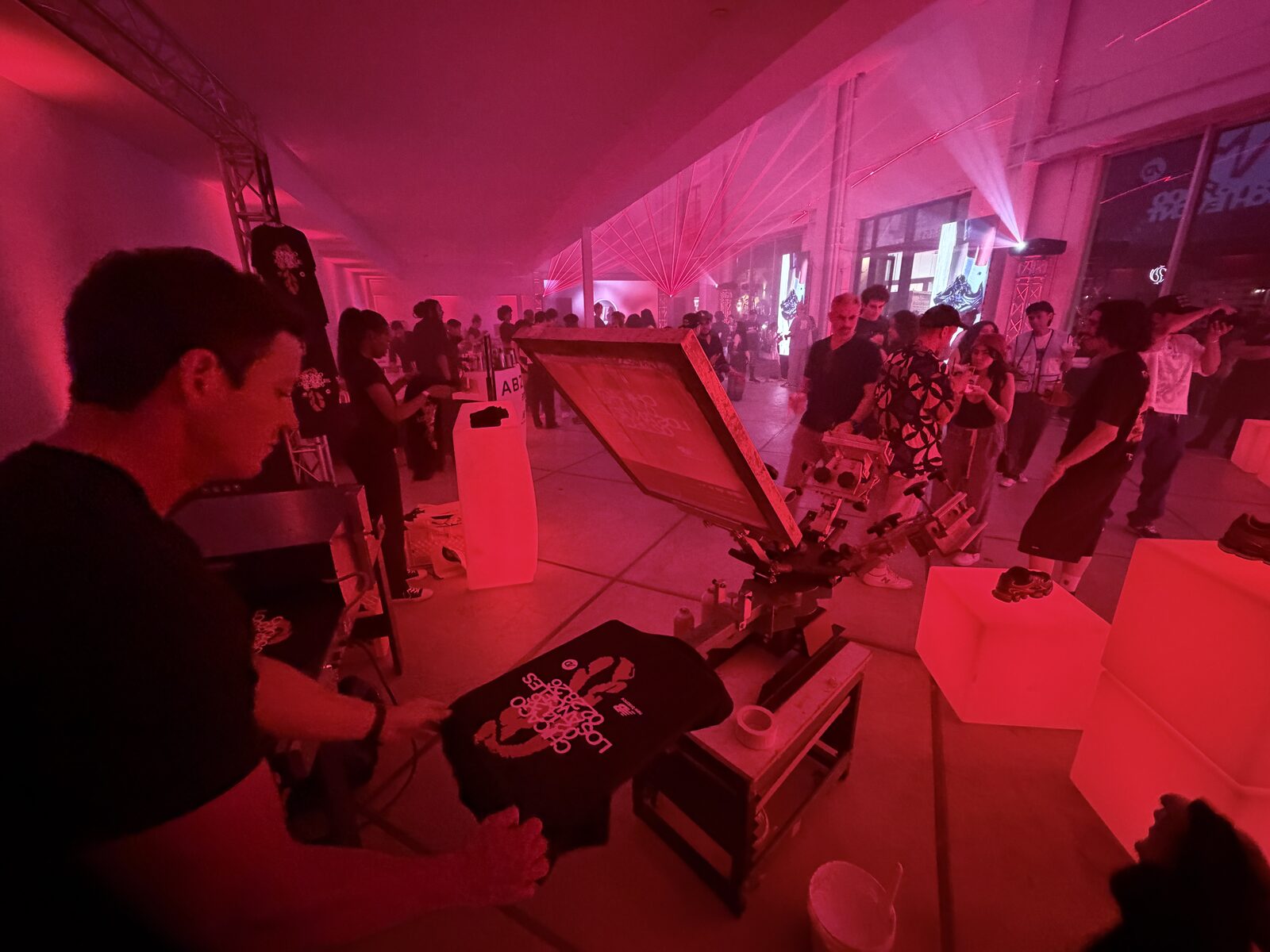 A freshly printed party shirt held up at a live wedding event